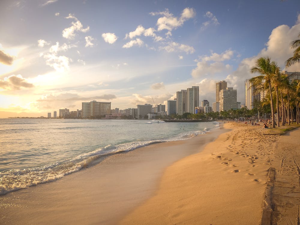 a beach with buildings and water: "Hawaii's November Weather"
